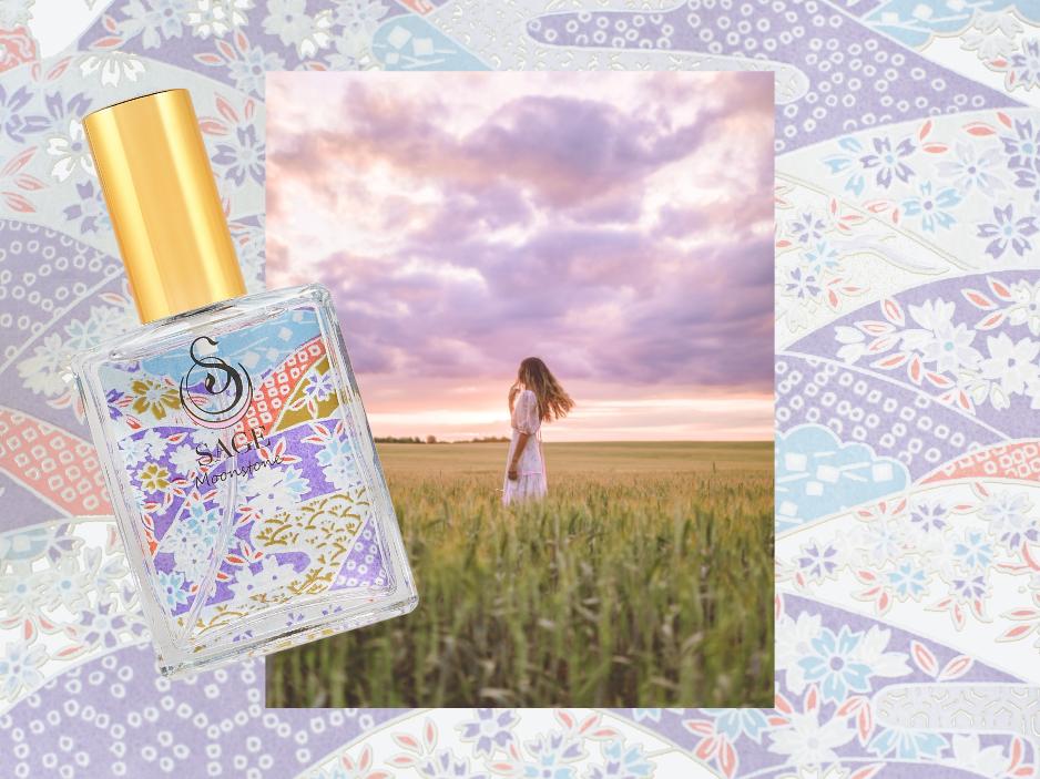 2 oz Sage Moonstone perfume spray, light floral, gender-neutral, vegan, cruelty free fragrance, next to woman in a big field