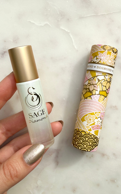 Sage Diamond rollerball and its packaging on a marble surface