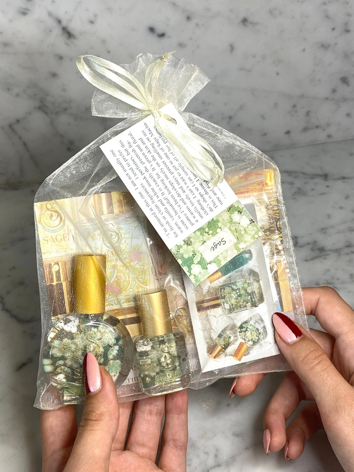 hands holding 1/4 oz Sage petite gift set: diamond, sage, turquoise,perfume oil roll on travel size fragrances